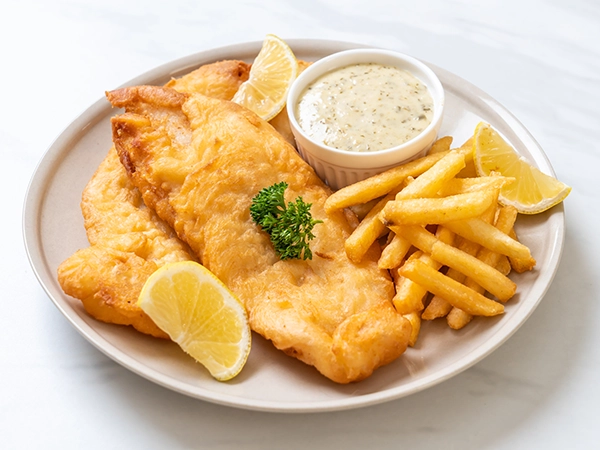 Ocean House fried fish dinner with fries, coleslaw and dipping sauce