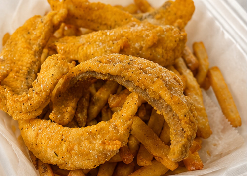 Ocean House fried seafood and fries served in a takeout container